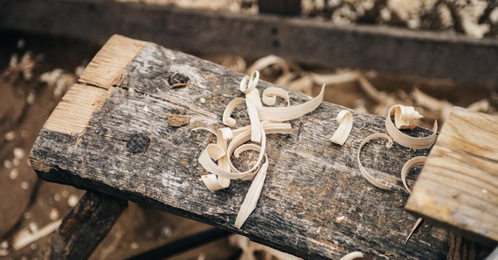 Rustic workbench covered in wood shavings, showcasing detailed craftsmanship.